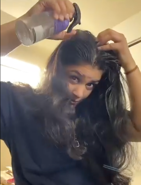 Customer applying product to scalp